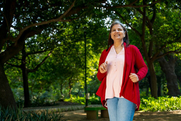 Indian woman doing exercise or jogging at park.