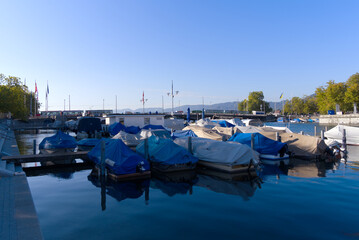 Medieval old town of Zürich with Limmat River and moored boats on a sunny late summer morning. Photo taken September 22nd, 2022, Zurich, Switzerland.