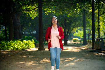 Indian woman doing exercise or jogging at park.