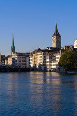 Beautiful cityscape of the old town of Zürich with church towers and Limmat River in the foreground on a sunny late summer morning. Photo taken September 22nd, 2022, Zurich, Switzerland.