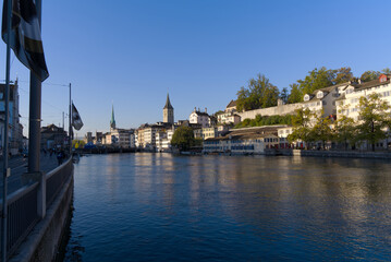 Beautiful cityscape of the old town of Zürich with church towers and Limmat River in the foreground on a sunny late summer morning. Photo taken September 22nd, 2022, Zurich, Switzerland.