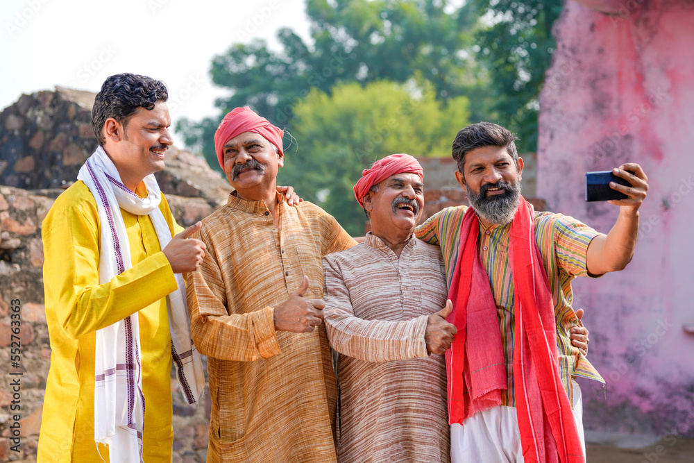 Wall mural indian villagers group taking selfie in smartphone