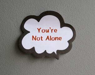 Speech sticker word balloon with handwriting text - You’re Not Alone - to support struggling...