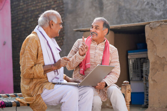 Two Indian Old Man Using Laptop At Out Of Home