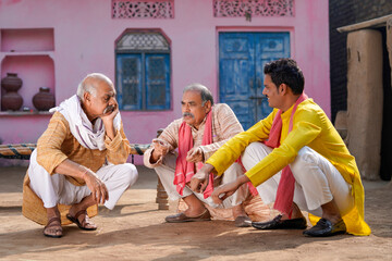 Three indian villagers discussing at out of home.