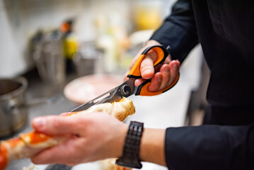 Close up hand of chef in restaurant cooking crab leg
