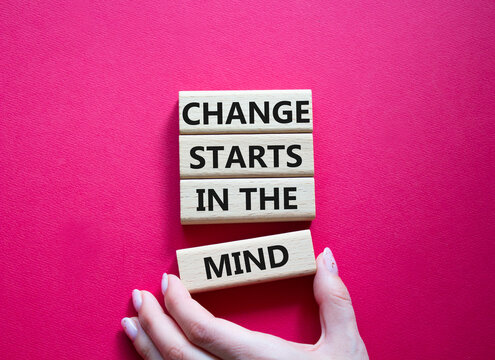 Change starts in the mind symbol. Concept words Change starts in the mind on wooden blocks. Beautiful red background. Businessman hand. Business and Change starts in the mind concept. Copy space