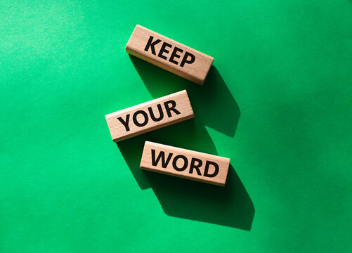 Keep your word symbol. Wooden blocks with words Keep your word. Beautiful green background. Business and Keep your word concept. Copy space.