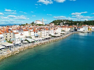 Waterfront Piran town in Slovenia on sunny day drone aerial view