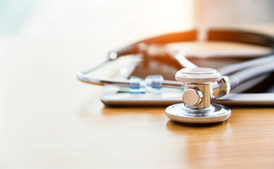 Digital tablet and stethoscope on table