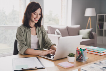 Photo of positive pretty lady secretary realtor look netbook search variants apartment house for...
