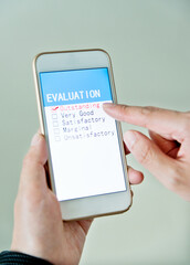 Hand holding smartphone with customer service survey form on screen