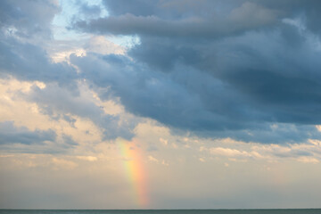 rainbow on the sea in cloudy weather