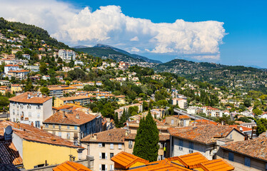 Panoramic view of eastern slope of lower city and Coast Cote d'Azur Alps mountains seen from old town quarter of perfumery city of Grasse in France