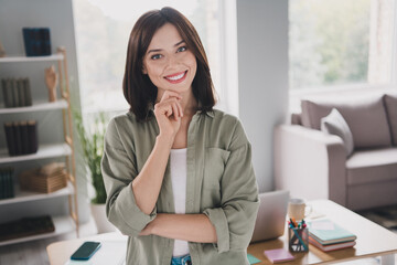 Photo of pretty cheerful clever person toothy smile arm touch chin spacious bright office indoors