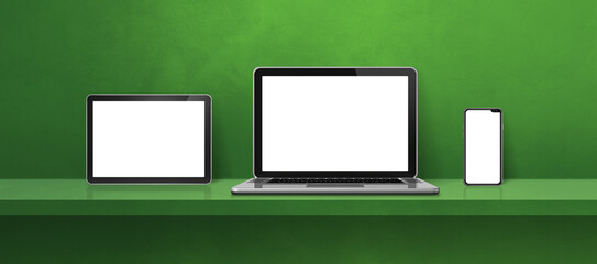 Laptop, mobile phone and digital tablet pc on green wall shelf. Banner background