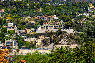 Obraz premium Residential area rising above harbor beach onshore Azure Cost of Mediterranean Sea in Villefranche-sur-Mer resort town in France