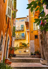 Narrow streets and colorful historic houses of old town quarter with Rue Baron de Bres street in Villefranche-sur-Mer resort town in France