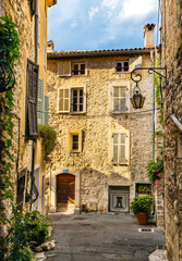 Fototapeta na wymiar Narrow streets and colorful historic houses of old town quarter with Rue de la Place Vieille street in medieval riviera resort of Vence in France