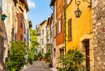 Narrow streets and colorful historic houses of old town quarter with Rue de la Coste street in medieval riviera resort of Vence in France