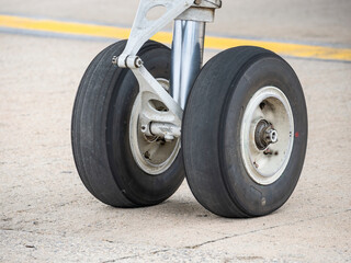Close up detail with a landing gear of a airplane. Aircraft tires wheels