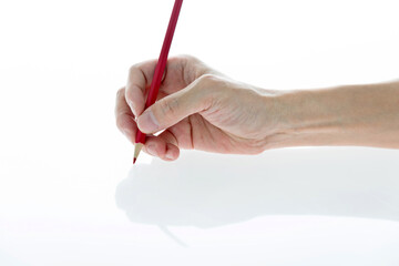 Man hand holding a pencil on white background