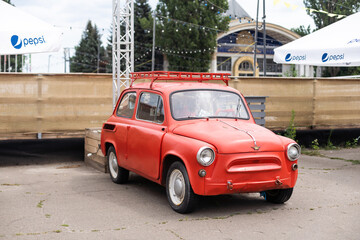 Little red car running in the city. 25 August 2022 - Ukraine, Kyiv