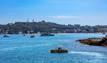 Panoramic view of harbor and exclusive residential peninsula along Plage del la Salis beach onshore...