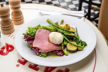 Salad with beef, grilled vegetables and poached egg