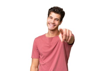 Young handsome caucasian man over isolated background points finger at you with a confident expression