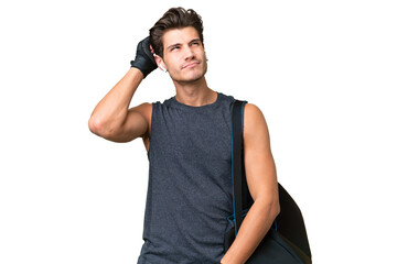Young sport caucasian man with sport bag over over isolated background having doubts and with confuse face expression