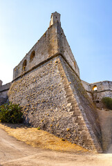 Defense walls and towers of medieval fortress Fort Carre castle in Antibes resort city onshore...