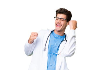 Young doctor man over isolated background celebrating a victory