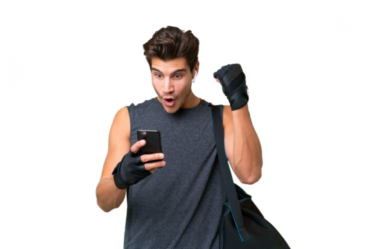 Young sport caucasian man with sport bag over over isolated background surprised and sending a message