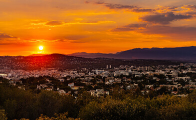 Panoramic sunset Juan Les Pins harbor and district of Antibes resort city onshore Azure Cost of...