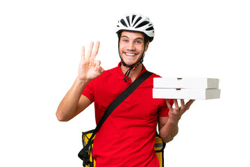 Pizza delivery man with work uniform picking up pizza boxes over isolated background happy and...