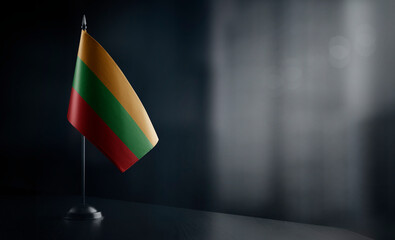 Small national flag of the Lithuania on a black background