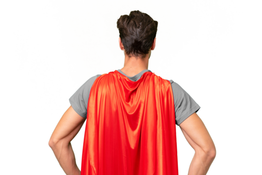Young handsome caucasian man over isolated background in superhero costume in back position