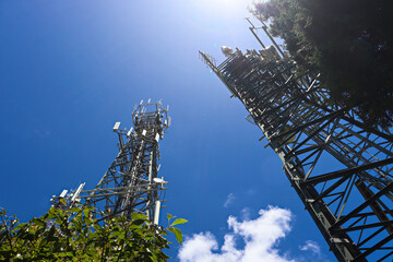 Looking up at tall radio and television towers on a blue sky day, Gan Gan communications site, Port Stephens.