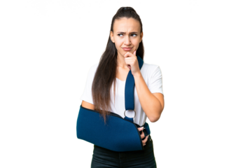 Young Arabian woman with broken arm and wearing a sling over isolated chroma key background having doubts and thinking