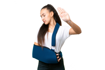 Young Arabian woman with broken arm and wearing a sling over isolated chroma key background making stop gesture and disappointed