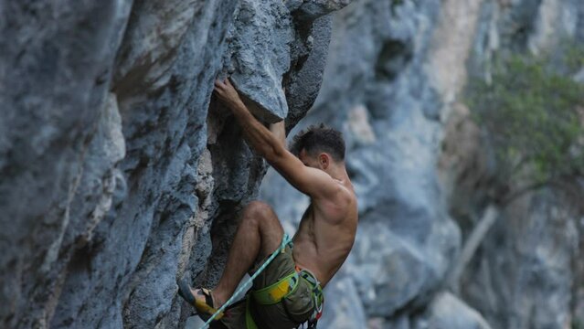 strong man climbs a beautiful rock. the concept of freedom and adventure.