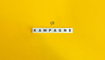 Kampagne (Word Campaign in German Language). Word and Megaphone Icon on Block Letter Tiles on...