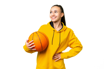 Young Arabian woman playing basketball over isolated wall  over isolated chroma key background posing with arms at hip and smiling