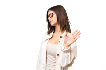 Young Russian woman over isolated chroma key background making stop gesture and disappointed