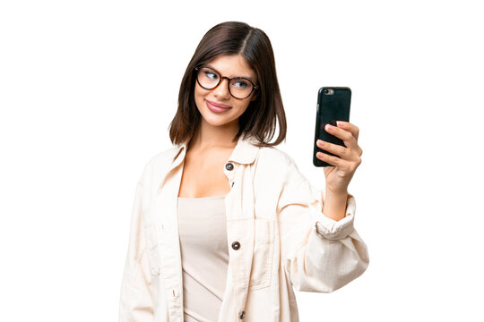 Young Russian woman over isolated chroma key background making a selfie
