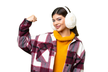 Young Russian woman wearing winter muffs over isolated chroma key background doing strong gesture