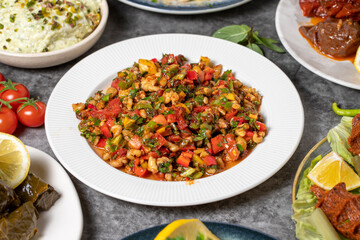 Traditional Turkish and Greek dinner appetizer table. Mediterranean appetizer concept. Dry cowpea salad, roasted eggplant salad, stuffed olives, stuffed peppers, gavurdagi salad