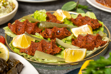 Traditional Turkish and Greek dinner appetizer table. Mediterranean appetizer concept. Raw meatballs, roasted eggplant salad, stuffed olives, stuffed peppers, gavurdagi salad