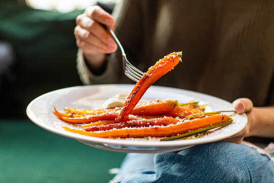 Girl holding a baked sweet potato on a fork